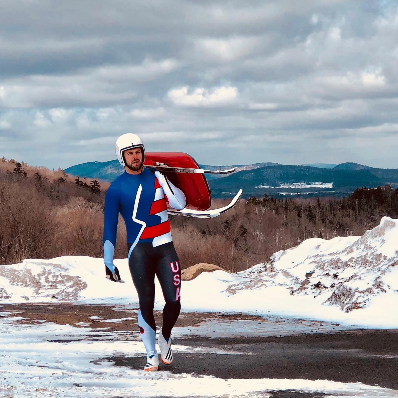 Chris Mazdzer carrying his luge