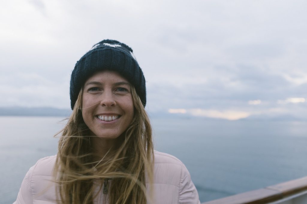 Torah Bright standing on a boat in Antarctica